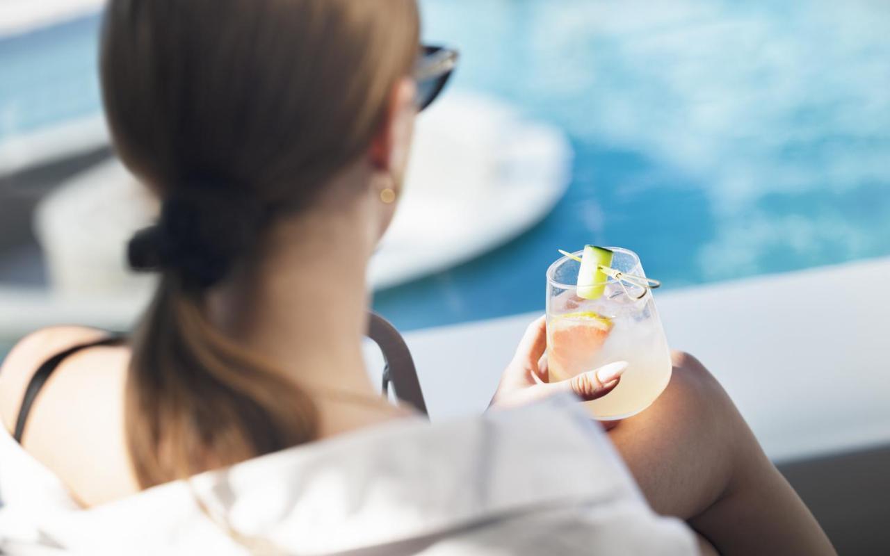 Nautilux Rethymno By Mage Hotels Экстерьер фото A woman holding a glass of wine